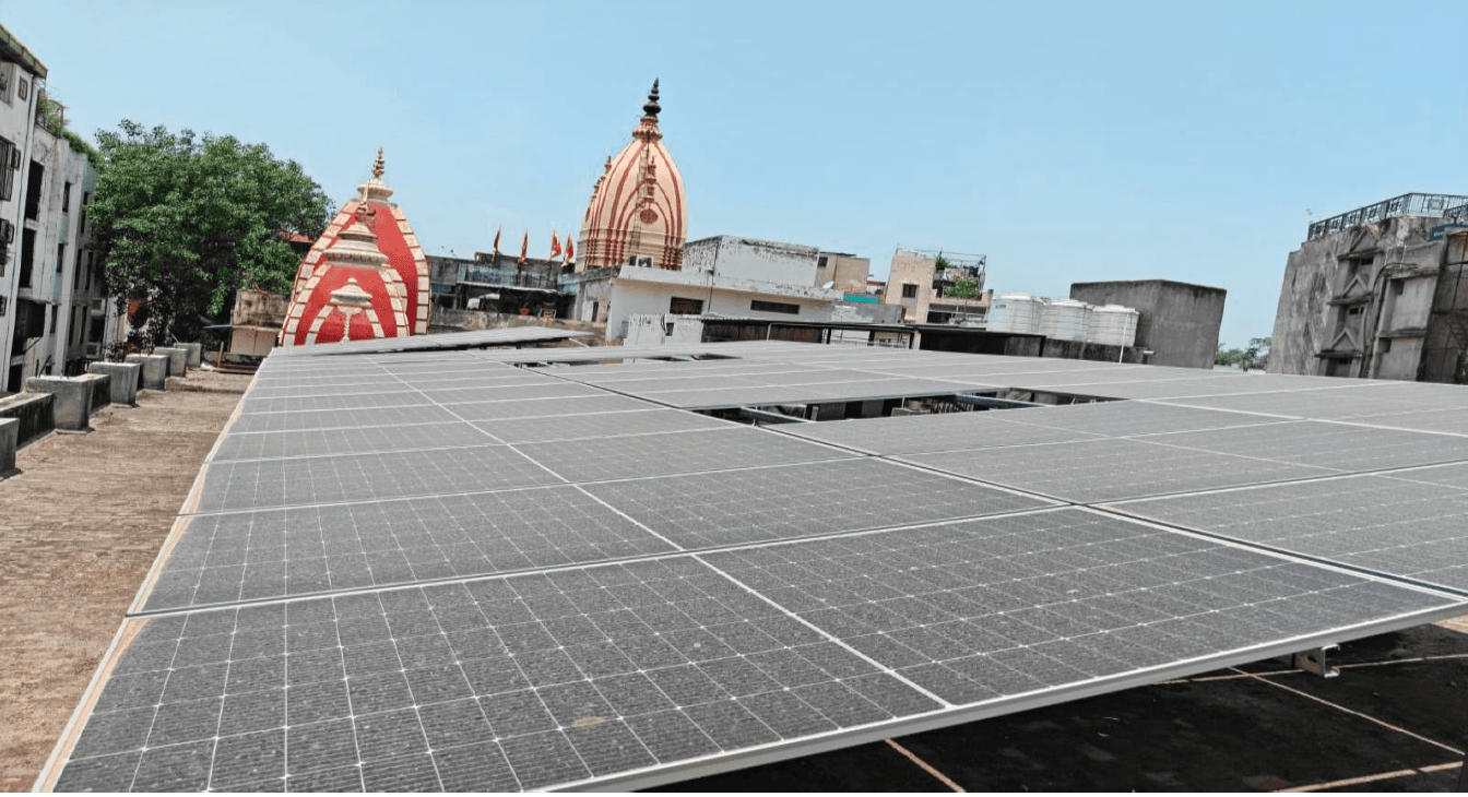 Solar panels installed on the temple roof, with the temple spires in the background