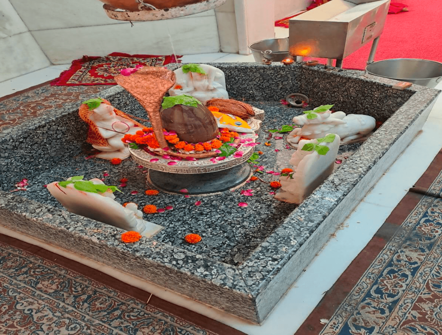 Shivling in its stone basin, where the water offered is collected and returned to the earth